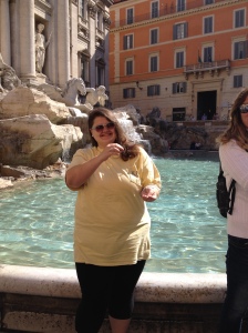Me tossing some coins into the Trevi Fountain.